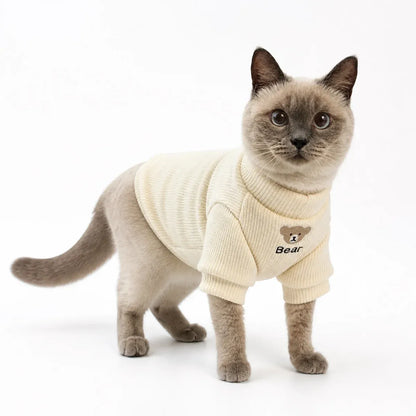 Cream fleece lined bear patch cat sweater worn by a pet on a white background