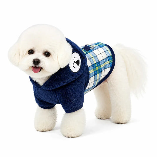 Dog wearing a navy plaid four-leg padded coat on a pure white background