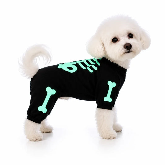 White dog wearing a black glow-in-the-dark skeleton dog costume