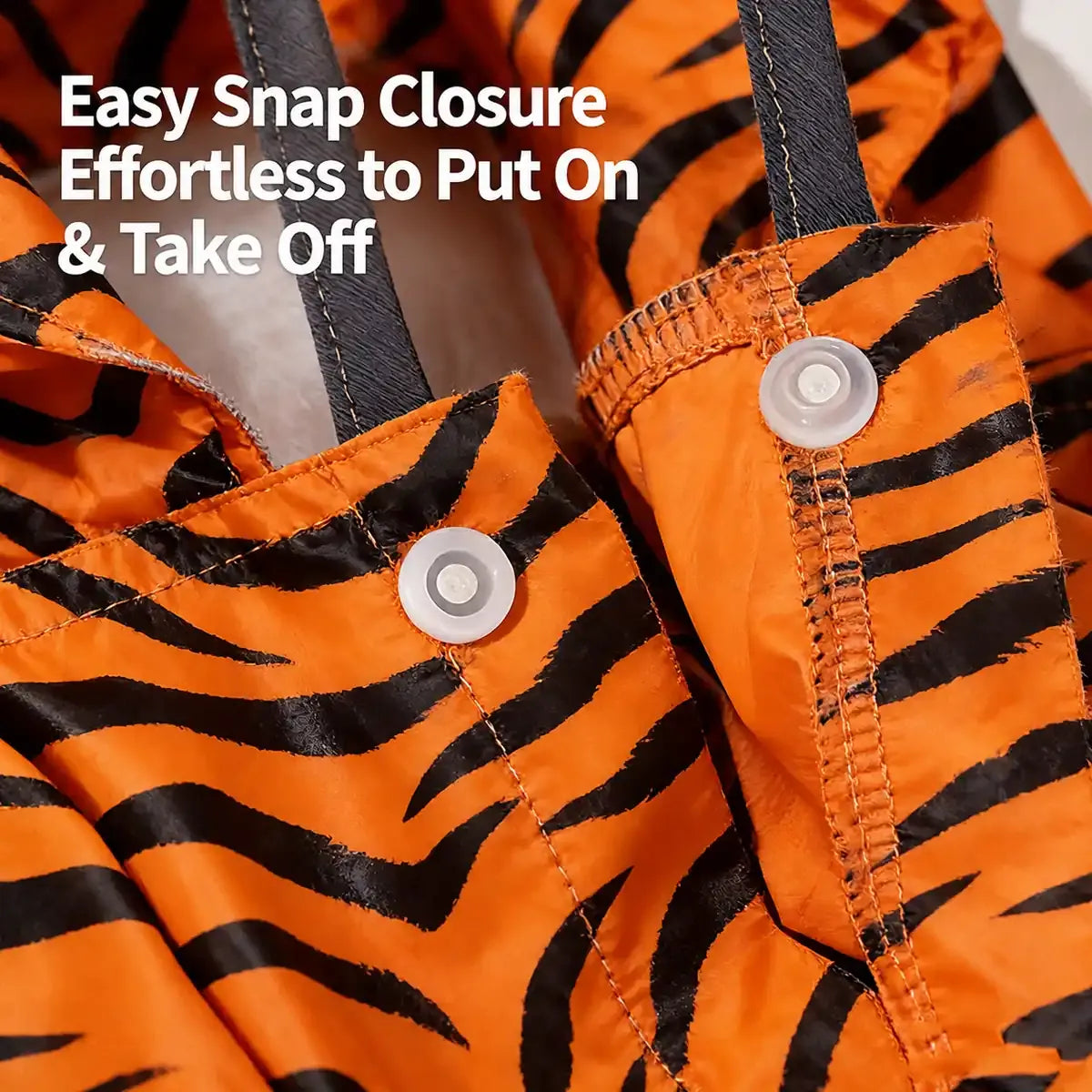 Close-up of orange tiger print full-coverage dog raincoat with snap closures